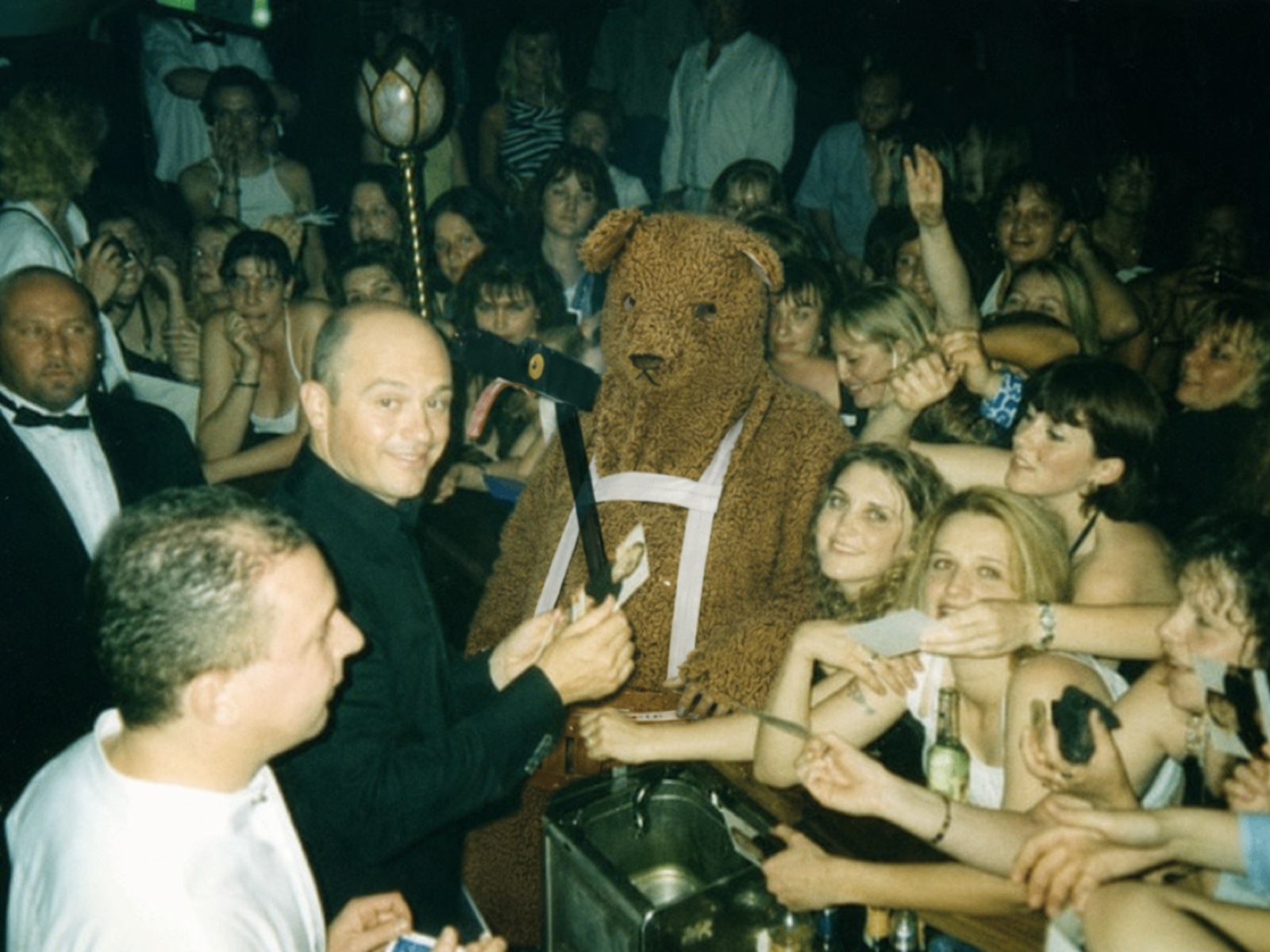 The Bear performing among a nightclub crowd