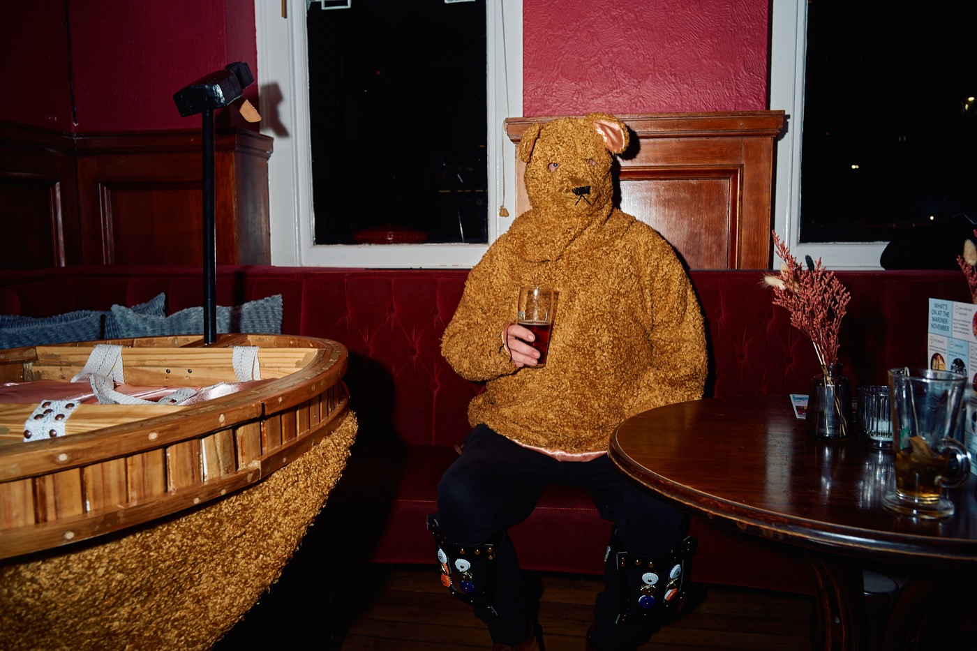 The Bear seated beside the portable ring in a pub