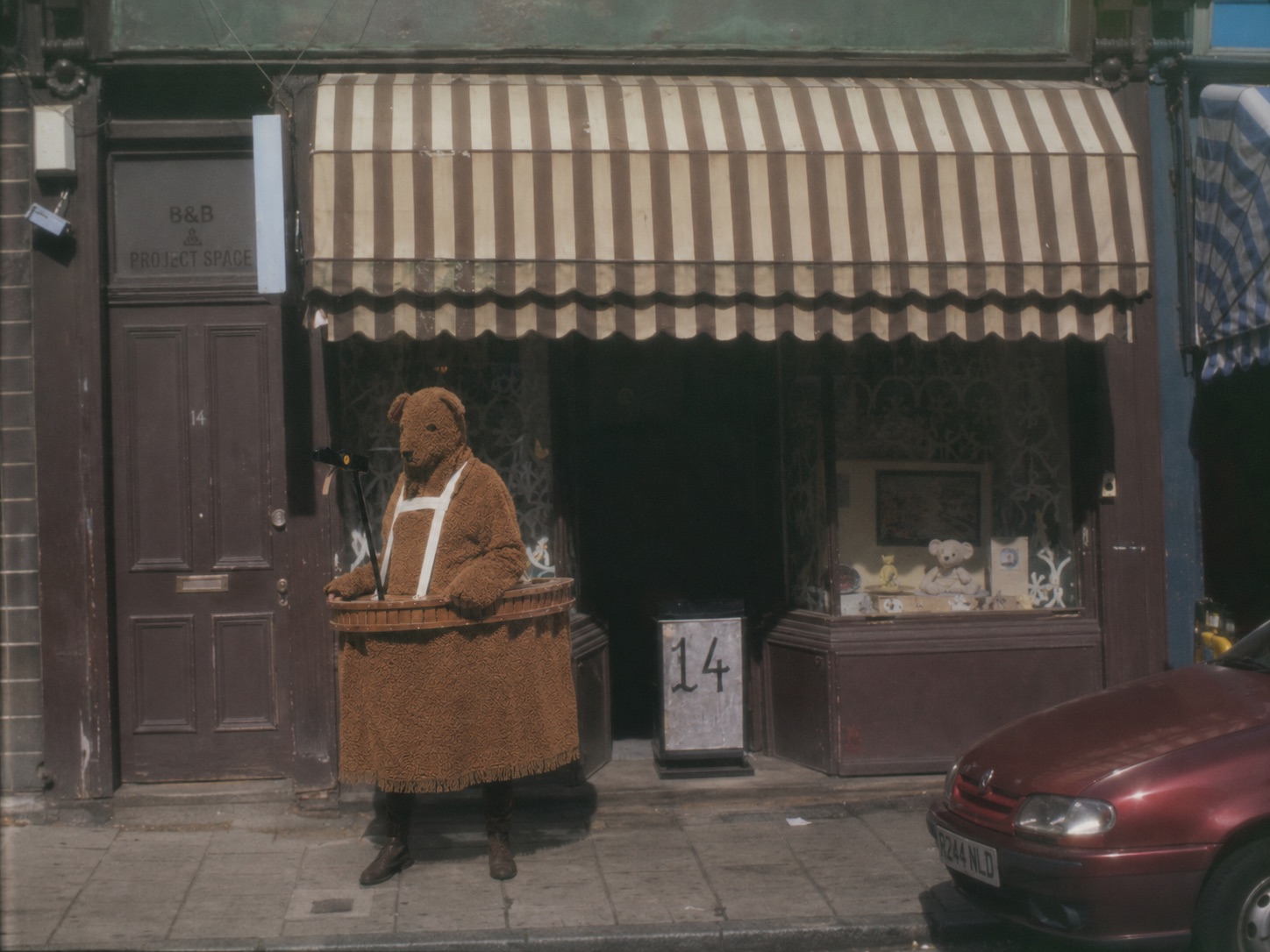 The Bear outside a small project-space shopfront marked number 14