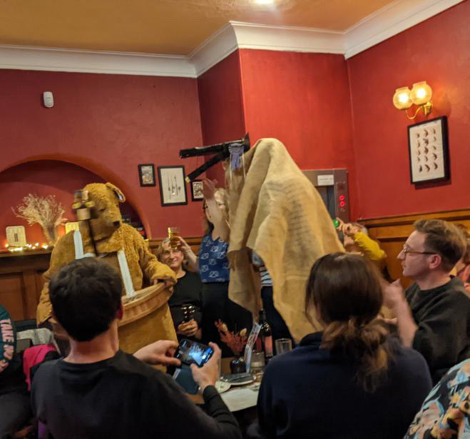 The Bear and Horse surrounded by audience members at the Mariner